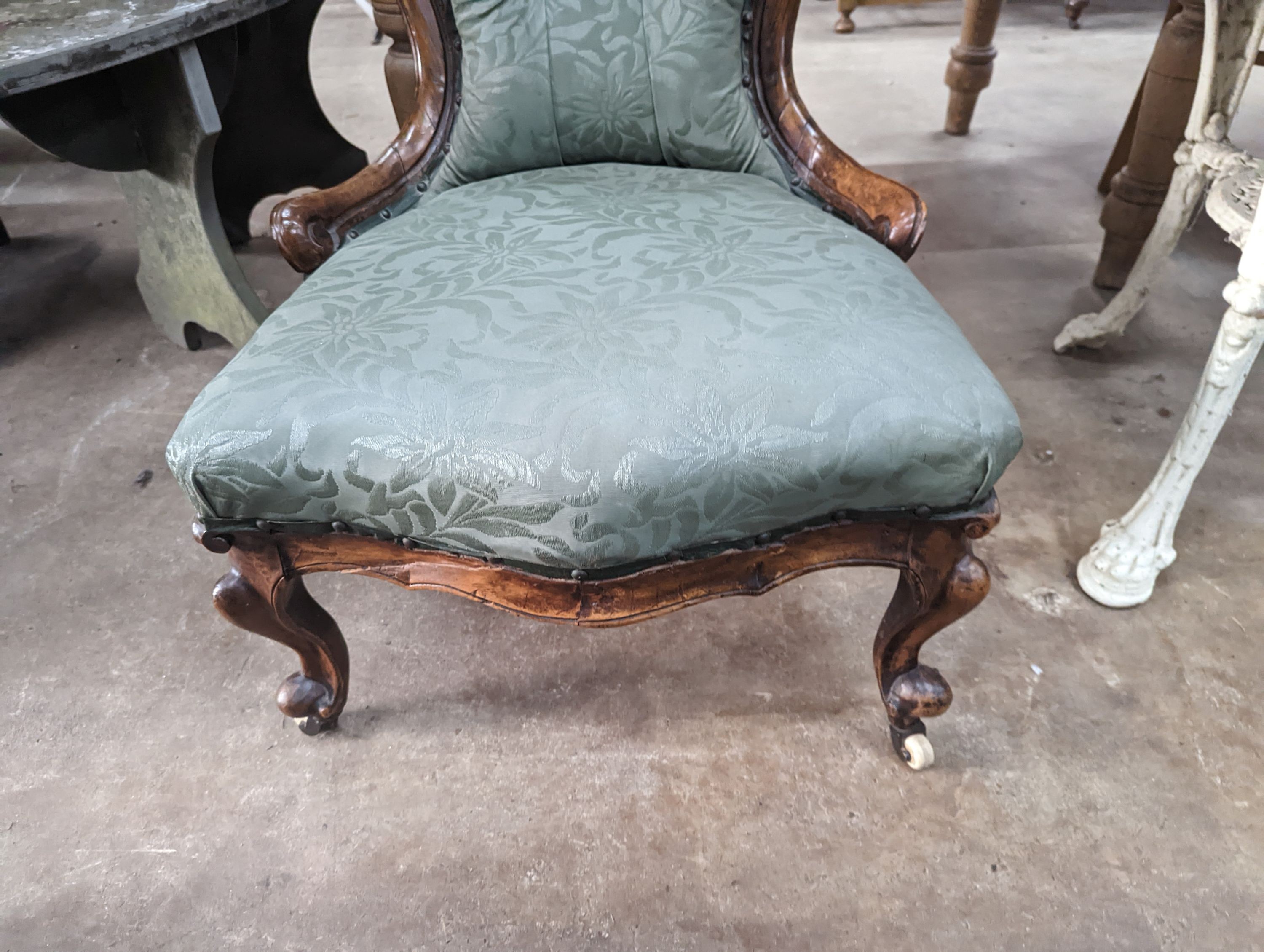 A Victorian walnut spoon back nursing chair